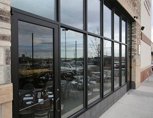 Dark aluminum commercial window wall on a restaurant